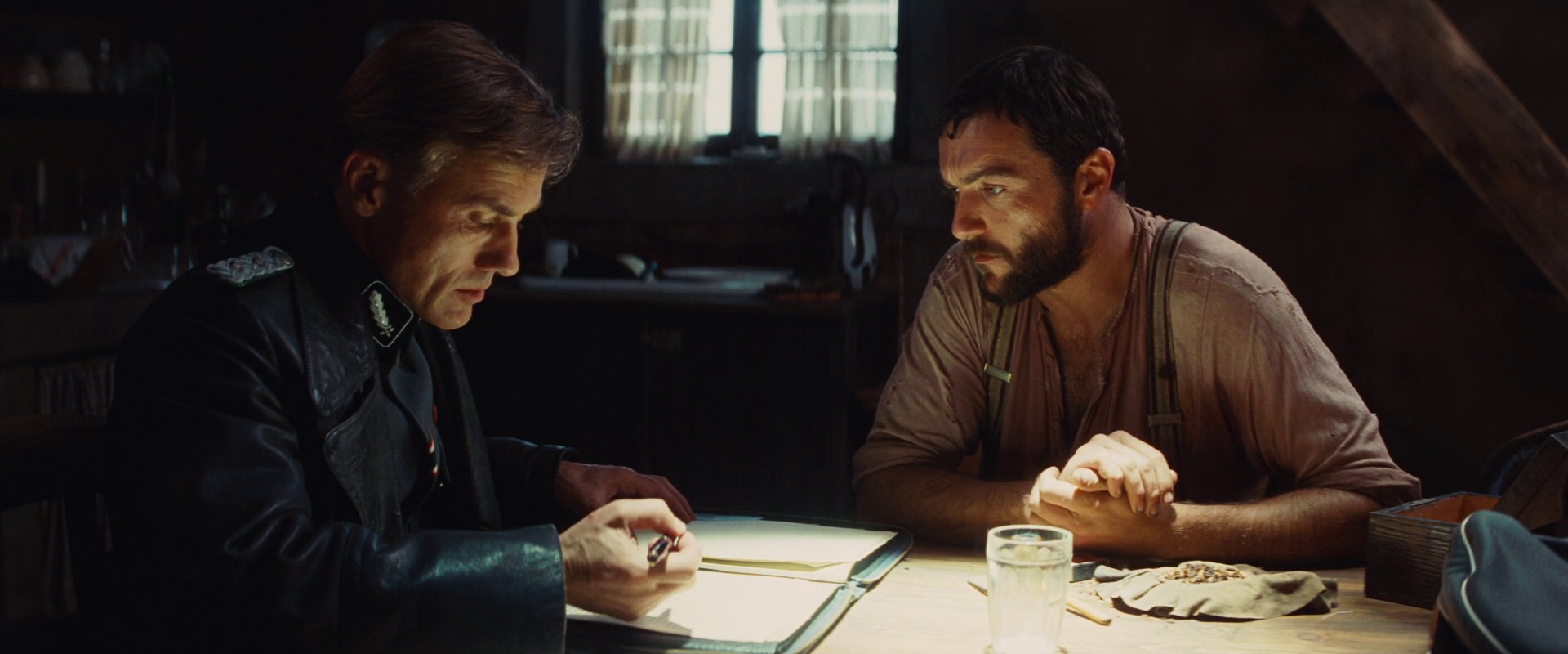 Hans_Landa_and_LaPadite_look_in_the_notebook